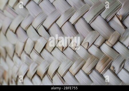 Abstract close-up natural brown woven wood bamboo texture backdrop, selective focus Stock Photo