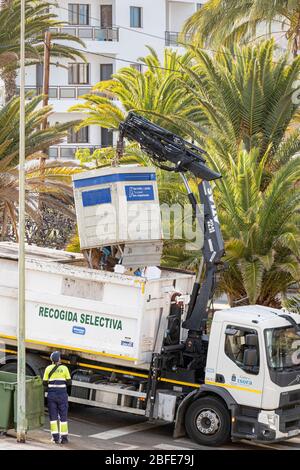 Recycling collection lorry emptying a bin into the back of the truck, Playa San Juan, Tenerife, Canary Islands, Spain Stock Photo