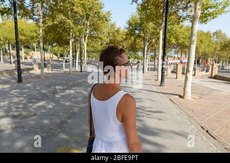 Back view of mature woman outdoors in park Stock Photo