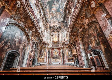 Feb 2, 2020 - Munich, Germany: Interior of Asamkirche baroque church with altar and ceiling view Stock Photo