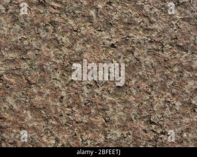 Red marble stone texture picture with reliefs in macro to highlight lighting effects at sunset Stock Photo