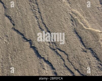 Grey stone texture picture with reliefs in macro to highlight lighting effects at sunset Stock Photo