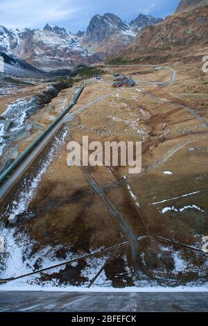 Wide angle shot along a dam wall photographed with an impairing mountain landscape Stock Photo