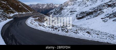 panorama of a winding road with snowy landscape in the ötztal in austria Stock Photo