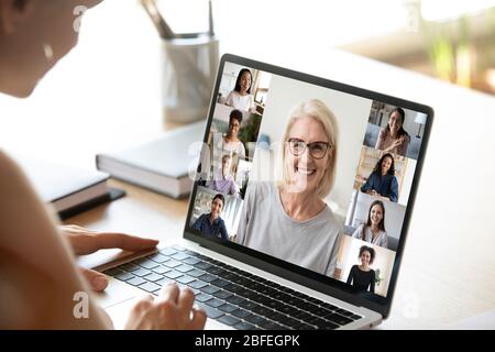 Diverse woman involved in group videocall, laptop screen view Stock Photo