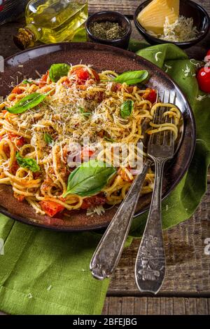 Traditional Italian pasta marinara. Classic recipe Roman food - pasta bucatini amatricana, with basil leaves on wooden rustic background Stock Photo