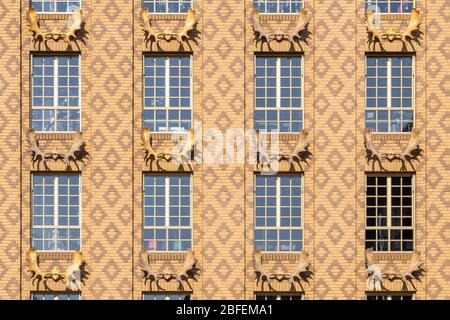 Beige dutch brick facade with deer antlers and diamond brick pattern Stock Photo