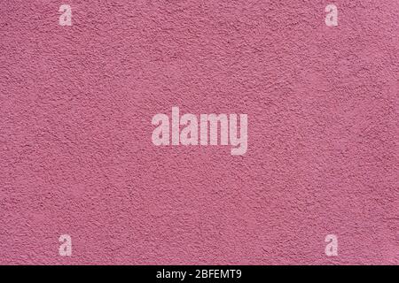 Texture of pink or purple painted and plastered building wall Stock Photo