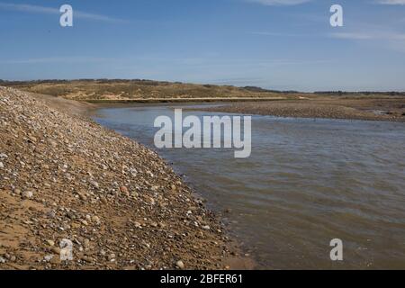 Ogmore river near its mouth in Merthyr Mawr nature reserve on sunny spring morning with steep slope on its bank Stock Photo