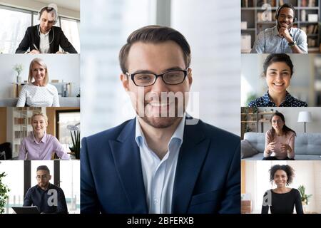 Laptop screen webcam view multiracial businesspeople involved in group videocall Stock Photo