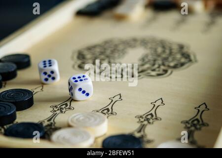 Backgammon wooden board with dices closeup. Happiness is in small things, enjoying life. Stock Photo