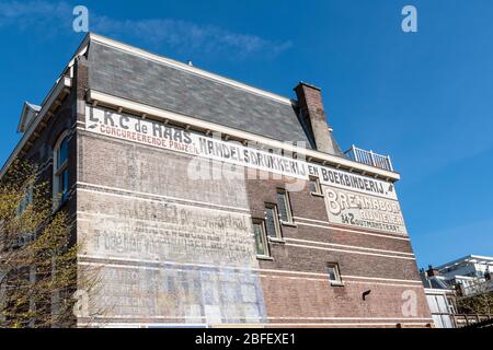 A large brick building with old Dutch advertisements Stock Photo