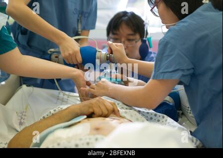 Medical staff use an oxygen tank to help revive a patient from general anaesthetic. Stock Photo