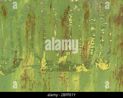 Corroded metal background. Rusted green and yellow painted metal wall. Rusty metal background with streaks of rust. Rust stains. The metal surface rus Stock Photo