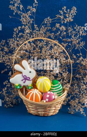Easter Bunny and bright colored eggs on a blue background. Spring chrestian holiday Stock Photo