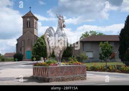 A huge statue of a chicken on the road in a village called Mantenay-Montlin near to Bourg en Bresse in France Stock Photo