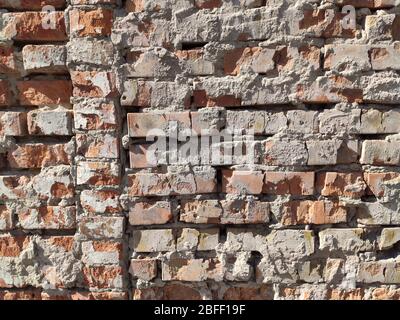 Old brick yellow background texture. Porous brick wall in temple at sunset Stock Photo