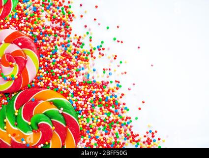 Sweet candies and lollipops, colorful sugar balls on white background Stock Photo
