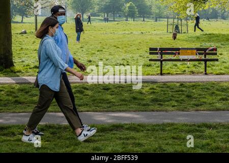 London, UK. 18th Apr, 2020. Clapham Common is pretty quiet now as it is colder and Lambeth Council has taped up all the benches, put up signs and organised patrols by wardens. The 'lockdown' continues for the Coronavirus (Covid 19) outbreak in London. Credit: Guy Bell/Alamy Live News