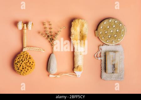 Natural spa and skincare beauty cleansing products with bathroom accessories including natural sponge, pumice stone and exfoliating soap with dry herbs. Flat lay pattern. Stock Photo