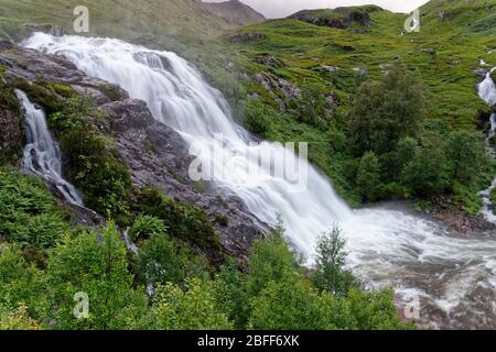 Glencoe or Allt Lairig Eilde Falls, Glen Coe, Highland, Scotland, UK Allt Lairig Eilde joins River Coe in spate after heavy rain Stock Photo