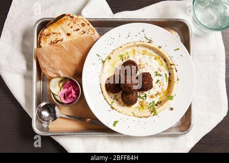 A healthy and hearty vegetarian and vegan meal featuring falafel and hummus Stock Photo