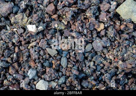 Slag from burnt coal. Coal ash close-up. Coal solid residue texture. Abstract multitask background. Selective focus. Stock Photo