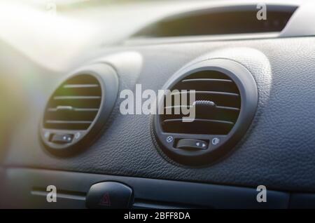 Elements of a car air conditioning. Details of the front panel of the car with air diffusers and an emergency stop button. The interior of the car. Sh Stock Photo