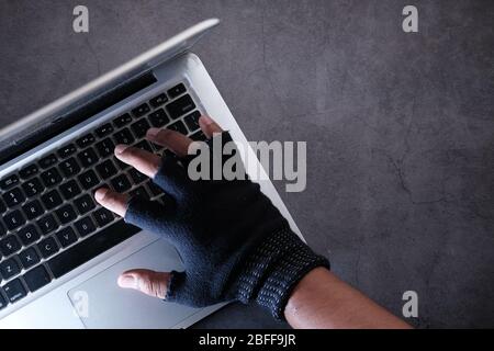 hacker hand stealing data from laptop, high angel view  Stock Photo