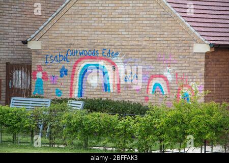 Colourful rainbow and thank you messages painted on a brick wall during the Covid19 pandemic lockdown Stock Photo