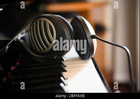 Headphone lying on a digital piano Stock Photo