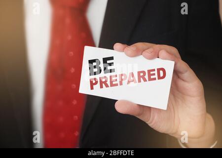 BE PREPARED, message on business card shown by a businessman. Business risk management concept Stock Photo