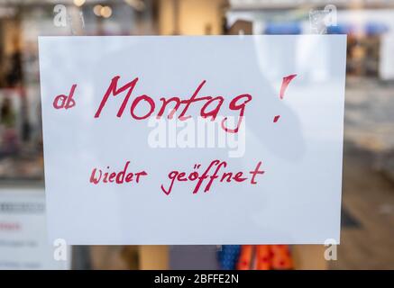 Herdecke, Germany. 18th Apr, 2020. 'Starting Monday! Open again' is written on a slip of paper attached to the door of a shoe store. After the long break due to the coronavirus pandemic, many shops in NRW are being prepared for reopening. Credit: Bernd Thissen/dpa/Alamy Live News Stock Photo