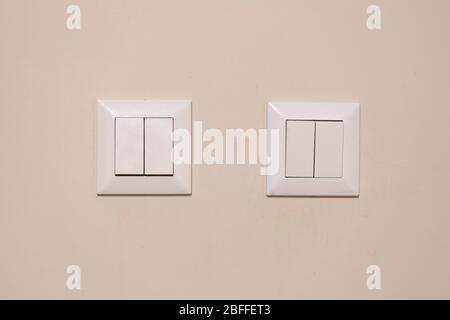 4 lamp switches close-up. They have a white color and are dirty and used. Indoor. Stock Photo