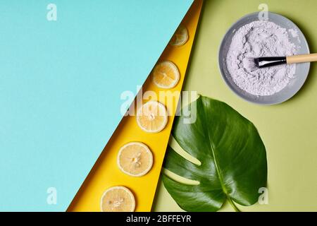 Beauty Care. Blue clay in cup isolated on blue yellow and green Stock Photo