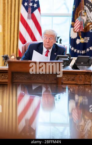 Washington, United States Of America. 18th Apr, 2020. President Donald J. Trump talks on the phone with Mexican President Andres Manuel Lopez Obrador Friday, April 17, 2020, in the Oval Office of the White House People: President Donald Trump Credit: Storms Media Group/Alamy Live News Stock Photo