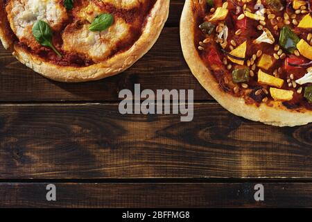 Flat lay of two vegan pizzas on dark rustic background Stock Photo