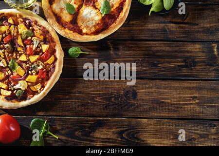 Top view of two vegan pizzas on dark rustic background Stock Photo