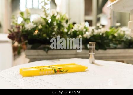 Baptism candles inside a church, just before the sacrament ceremony Stock Photo