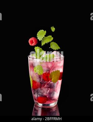 A glass with ice-cold infused water with raspberry Stock Photo