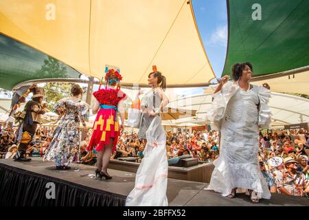 At a show of fashions made from found objects in Laguna Beach, CA, a runway full of models completes the fashion show. Stock Photo