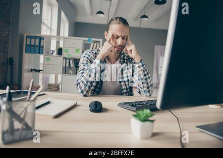 Photo of tired depressed business handsome guy holding fingers temples suffering feel dizzy work day night eyes closed wear casual outfit sitting Stock Photo