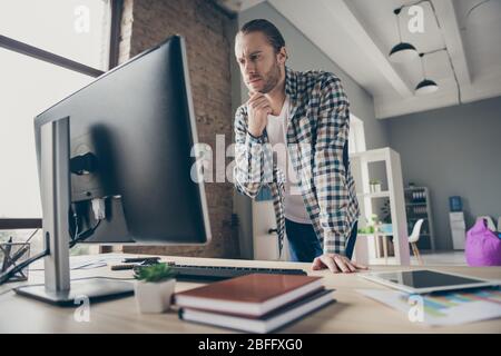 Photo of handsome business guy look computer monitor table waiting colleagues partners answer seriously reading report wear casual shirt standing Stock Photo