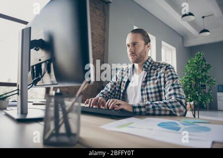Photo of handsome business guy look computer monitor table chatting colleagues partners seriously reading corporate report wear casual shirt suit Stock Photo