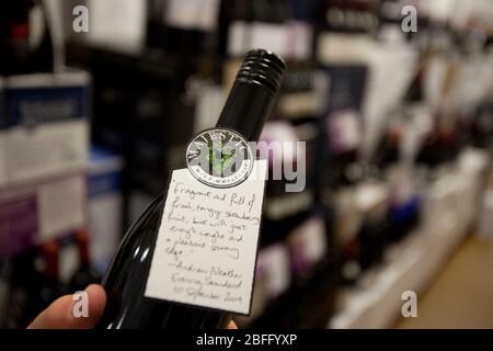 A customer reading the wine description of his selected bottle. Stock Photo