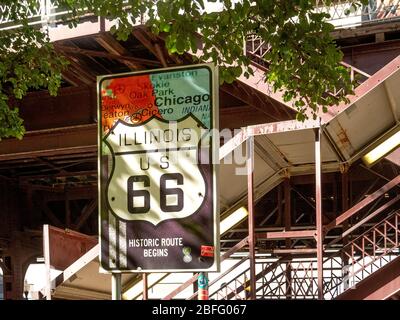 A sign in downtown Chicago marks the beginning of historic Route 66, also known as the Will Rogers Highway, the Main Street of America or the Mother Road. The highway, which became one of the most famous roads in the United States, originally ran from Chicago, Illinois, through Missouri, Kansas, Oklahoma, Texas, New Mexico, and Arizona before ending in Santa Monica in Los Angeles County, California, covering a total of 2,448 miles Stock Photo