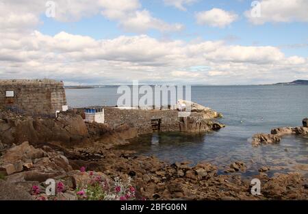 Swimmers in the Irish sea at the historic Forty Foot in Sandycove Stock Photo