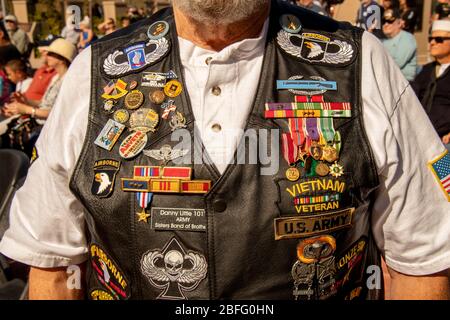 A Vietnam War veteran proudly shows off a vest covered with decorations from his wartime service at a patriotic observance in Costa Mesa, CA. Stock Photo