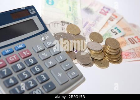 Illustrative image of various denomination sterling pound notes and coins. Stock Photo