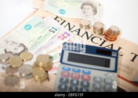 Illustrative image of various denomination sterling pound notes and coins. Stock Photo